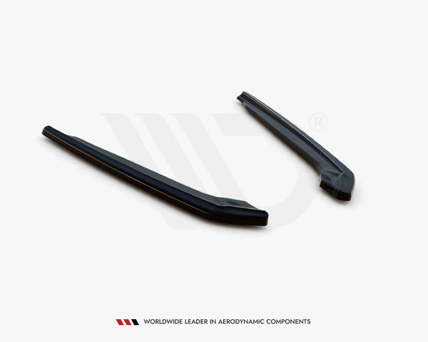 Two elongated, dark aerodynamic components lie parallel on a white surface. Text below reads, "WORLDWIDE LEADER IN AERODYNAMIC COMPONENTS."