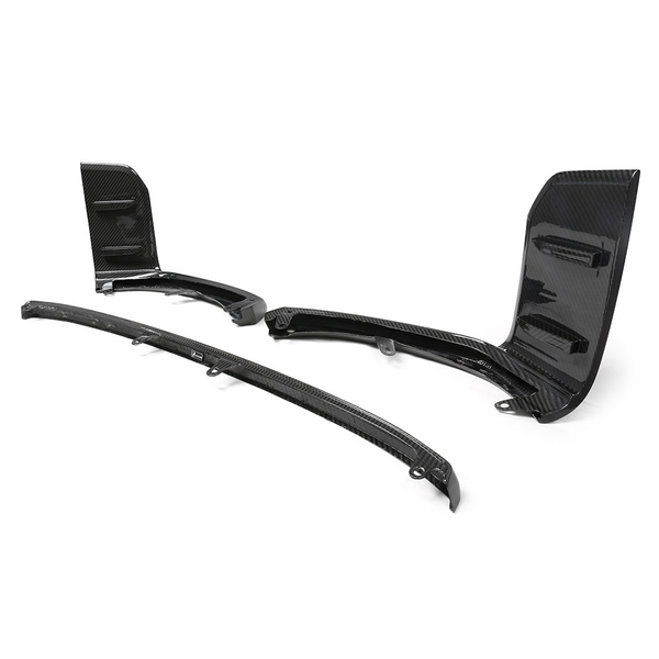 Carbon fiber car aerodynamic parts, including a splitter and winglets, rest on a white background. These components feature sleek, glossy surfaces with a textured, woven pattern.