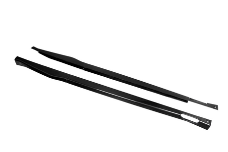 Two elongated carbon fiber side skirts, featuring a sleek design, rest parallel on a plain white background.
