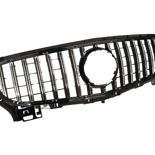 A black and chrome car grille with vertical slats and a central circular opening, positioned against a plain white background.