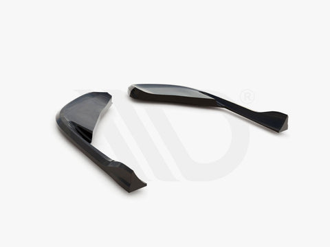 Two sleek, curved black aerodynamic components are positioned on a white surface. Below, text reads: "WORLDWIDE LEADER IN AERODYNAMIC COMPONENTS."