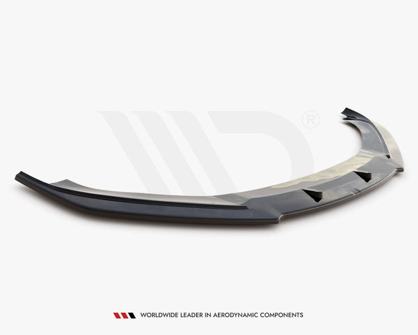 A glossy black car front splitter with aerodynamic fins rests on a white surface. Text reads: "WORLDWIDE LEADER IN AERODYNAMIC COMPONENTS."