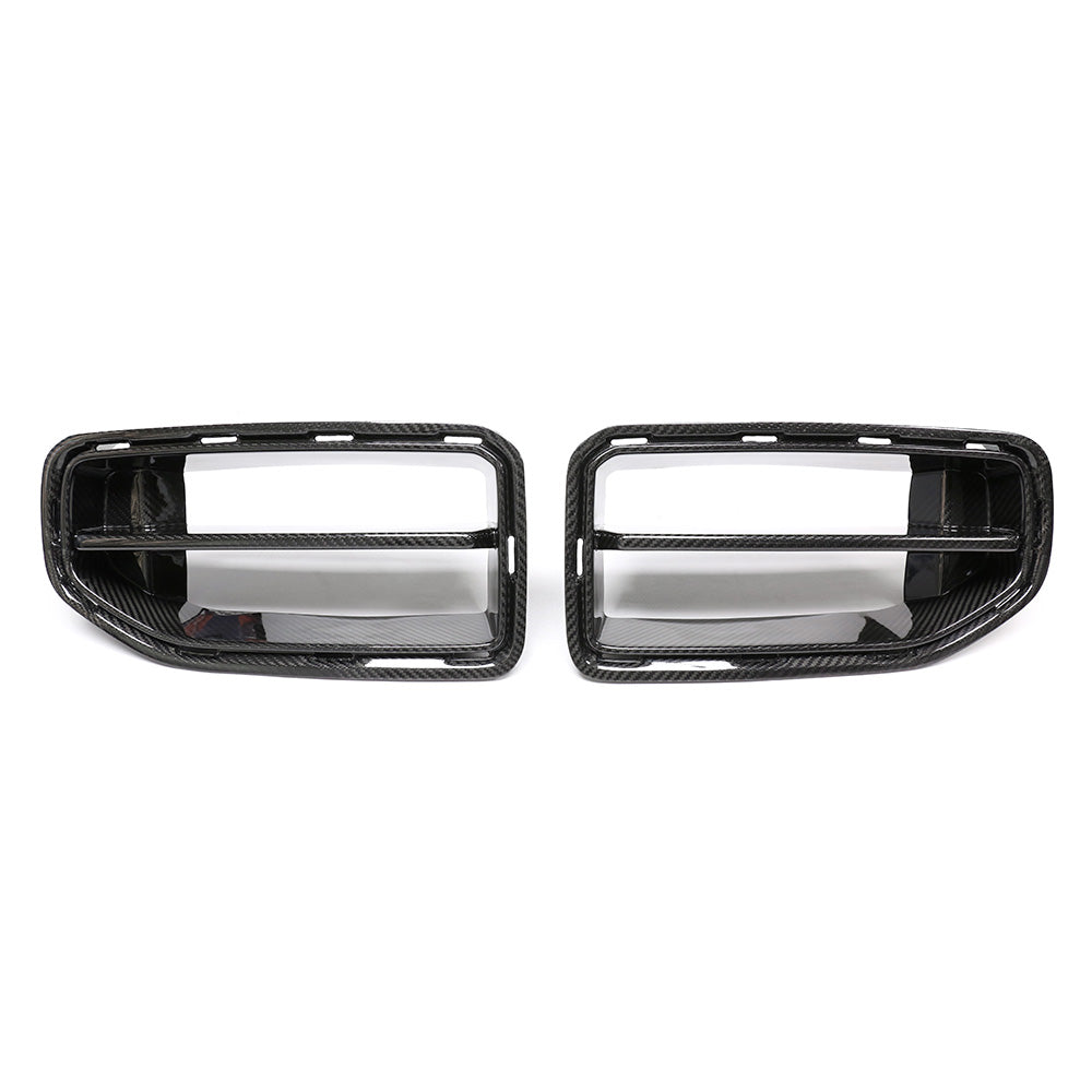 Two carbon fiber car grilles are placed side by side against a white background. Each grille features horizontal slats and a textured finish, indicative of automotive parts.