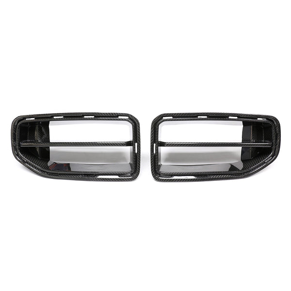 Two carbon fiber car grilles are placed side by side against a white background. Each grille features horizontal slats and a textured finish, indicative of automotive parts.