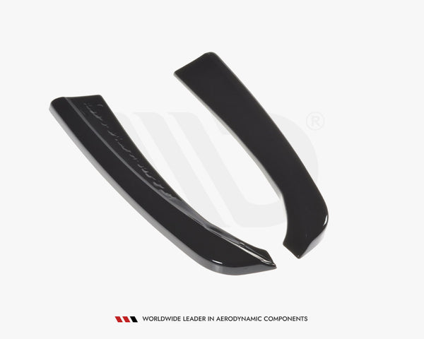 Two sleek, black curved aerodynamic components lie on a white surface. Text below reads: "WORLDWIDE LEADER IN AERODYNAMIC COMPONENTS."