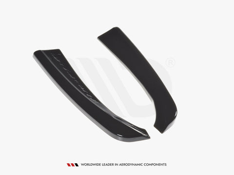 Two sleek, black curved aerodynamic components lie on a white surface. Text below reads: "WORLDWIDE LEADER IN AERODYNAMIC COMPONENTS."