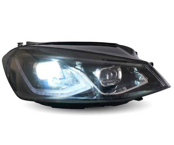A car headlight is illuminated brightly, showcasing its reflective interior design, set against a neutral, white background.