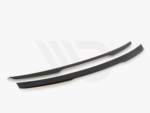Two sleek black aerodynamic components are displayed on a white background. They are thin, elongated, and slightly curved. Text below reads, "WORLDWIDE LEADER IN AERODYNAMIC COMPONENTS."