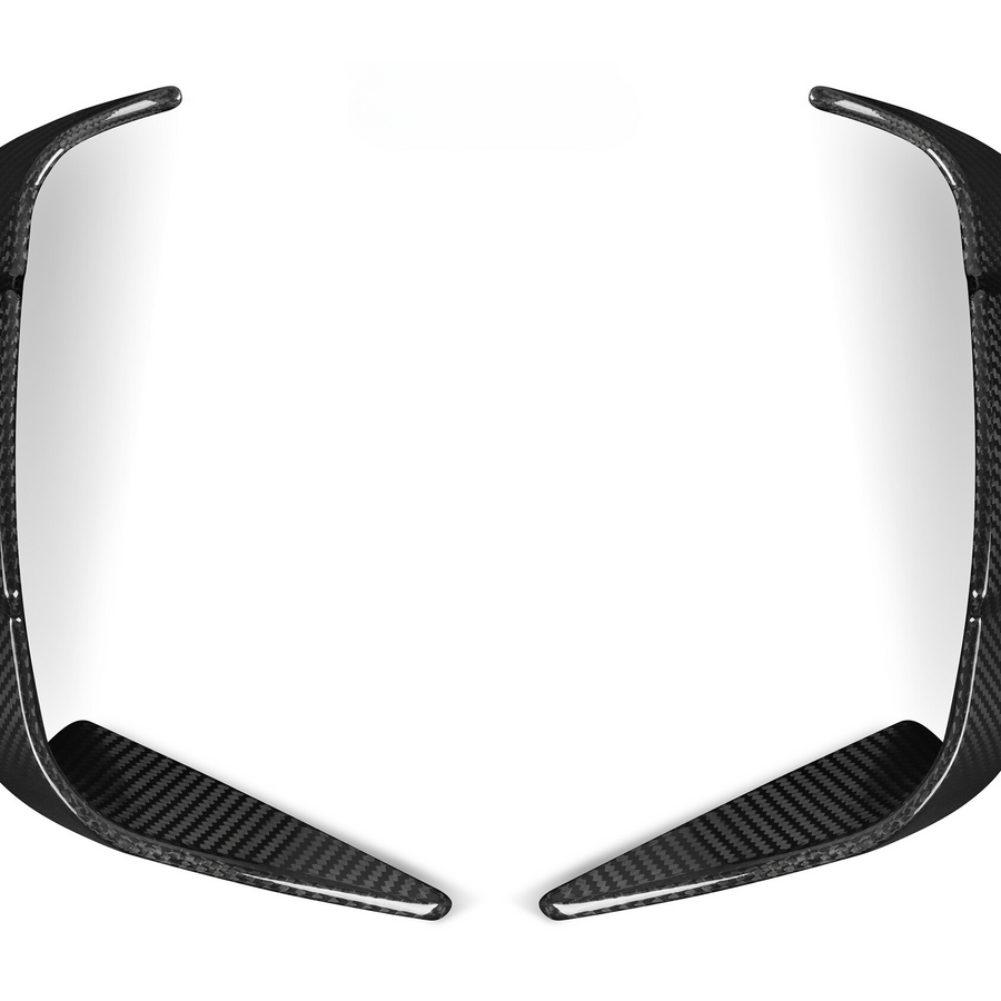 Two elongated, curved carbon fiber pieces rest symmetrically, facing each other on a plain white background.