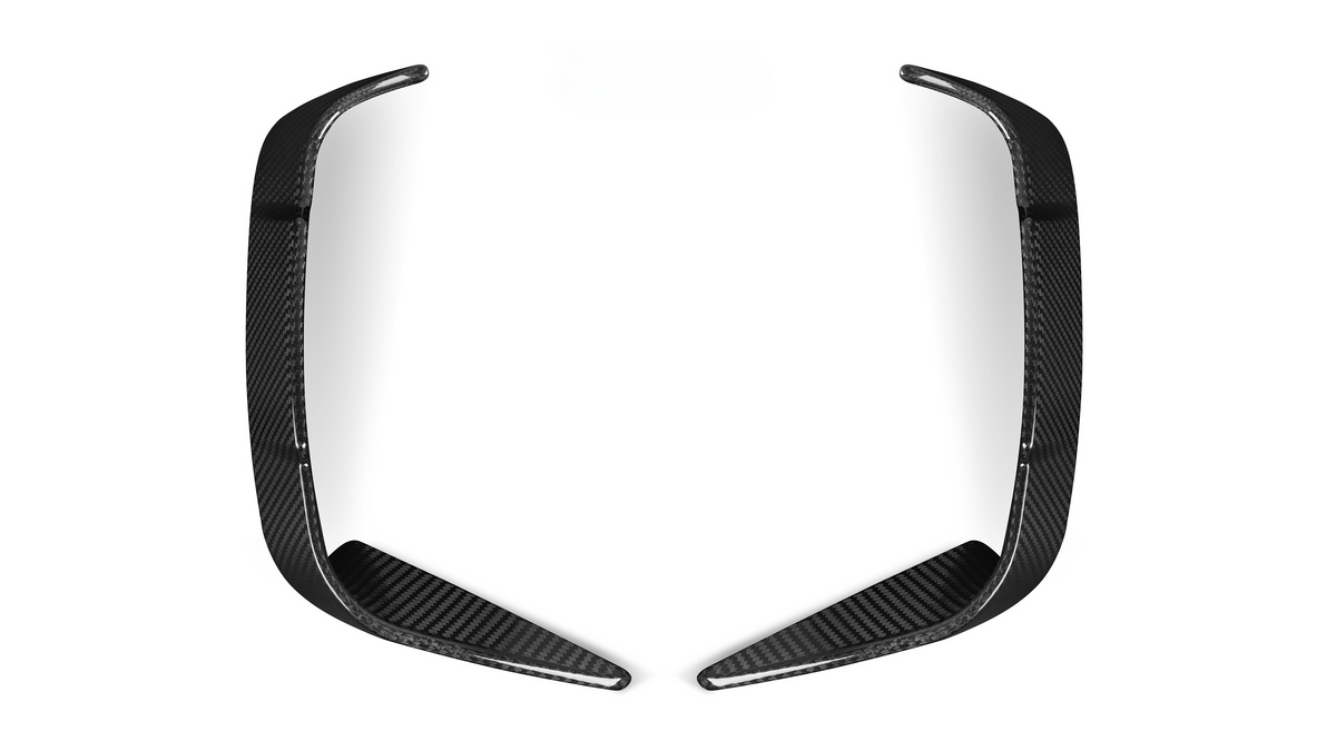 Two elongated, curved carbon fiber pieces rest symmetrically, facing each other on a plain white background.