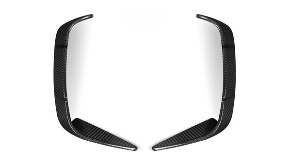 Two elongated, curved carbon fiber pieces rest symmetrically, facing each other on a plain white background.