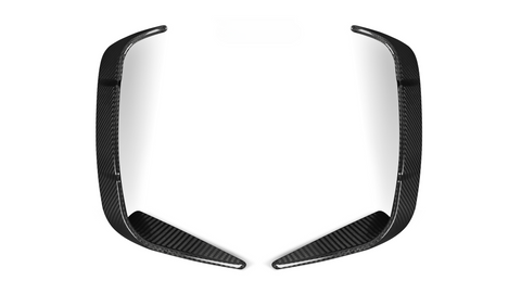 Two elongated, curved carbon fiber pieces rest symmetrically, facing each other on a plain white background.