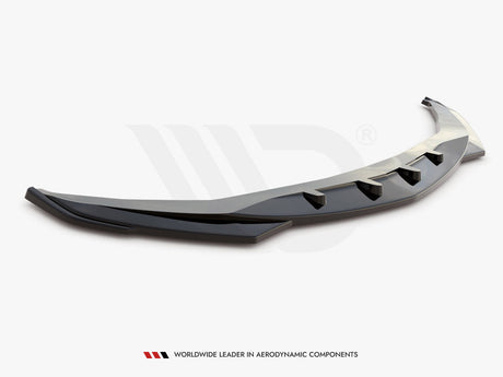 A sleek, black aerodynamic car component with fin-like protrusions rests on a plain white background. Text below reads: "Worldwide leader in aerodynamic components."