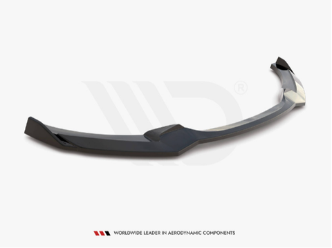 A sleek black car front splitter rests on a white surface, showcasing its aerodynamic design. Underneath, text reads: "WORLDWIDE LEADER IN AERODYNAMIC COMPONENTS."
