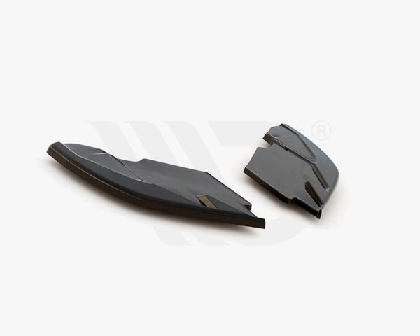 Two black aerodynamic components rest on a white surface, showcasing their sleek, angular design. Text below reads: "WORLDWIDE LEADER IN AERODYNAMIC COMPONENTS."