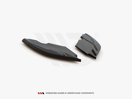 Two black aerodynamic components rest on a white surface, showcasing their sleek, angular design. Text below reads: "WORLDWIDE LEADER IN AERODYNAMIC COMPONENTS."