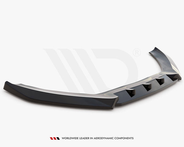 A black, angular car spoiler rests on a white surface, featuring multiple triangular cutouts. Text below reads: "WORLDWIDE LEADER IN AERODYNAMIC COMPONENTS."