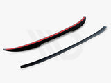 Two aerodynamic car components, both curved black strips with red accents, are placed on a white background. Text reads, 