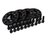 Black wheel spacers are arranged neatly, accompanied by multiple bolts aligned in front. The context is a plain white background. Some spacers display text: 