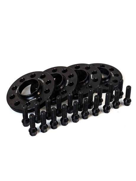 Black wheel spacers are arranged neatly, accompanied by multiple bolts aligned in front. The context is a plain white background. Some spacers display text: "S7-10-5885," "S90-160 4A."