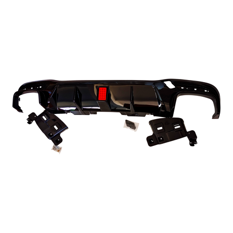 A glossy black car bumper diffuser features a central red reflector, surrounded by mounting brackets and bolts. The components are isolated on a white background.