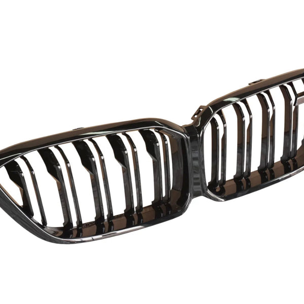 A shiny, black double-kidney car grill with vertical slats is laid out against a plain white background, likely for a vehicle's front exterior.