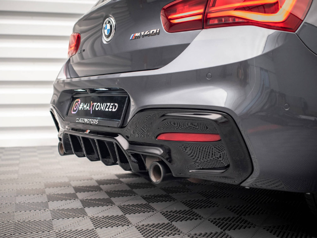 A grey BMW M240i is parked on a checkered floor indoors. It features a visible rear bumper with dual exhausts. The license plate reads "@WAYTONIZED" above "CARS'N'MOTORS."
