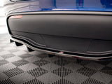 A blue car's rear bumper features a sleek aerodynamic design with a diffuser. A small 