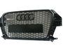 A black car grille with a honeycomb pattern, features four interlocking rings emblem and "RS Q3" text. The grille is designed for an Audi vehicle, displayed against a plain background.