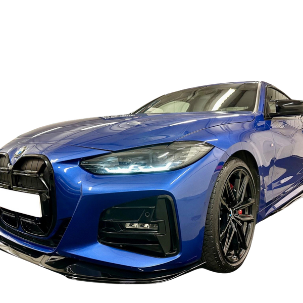 A blue sports car with a sleek design is parked against a black background, highlighting its modern headlights and black wheels. The front license plate area is blank.