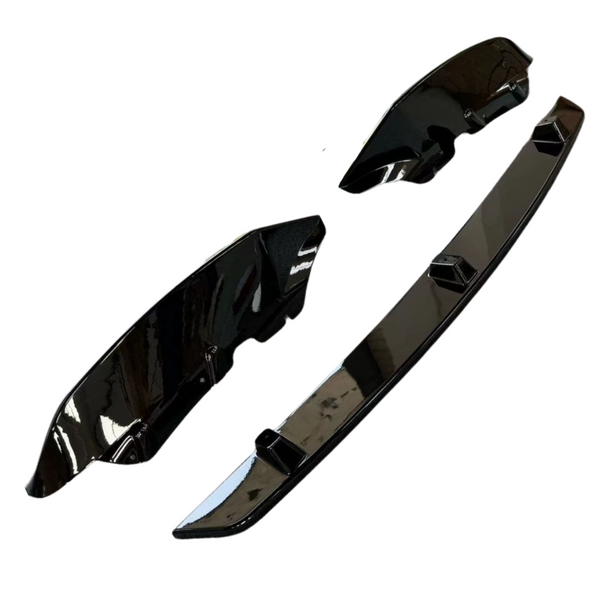 Three glossy black car parts, including a long bumper piece and two smaller side components, are arranged separately on a plain white background.