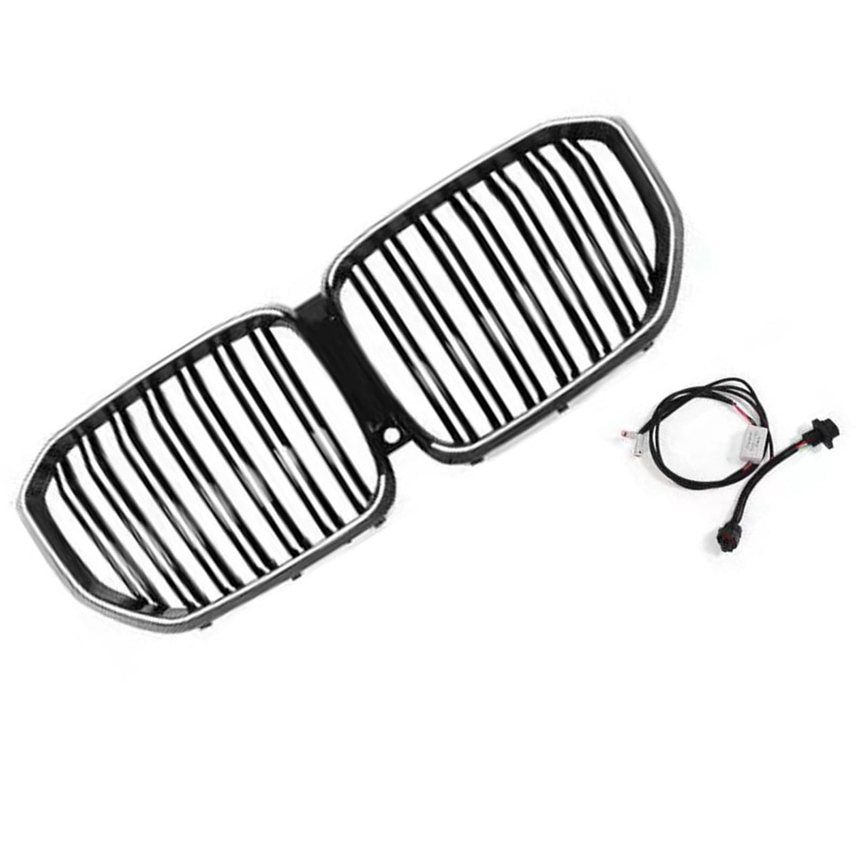 A dual-section car grille with vertical bars, black and chrome, lies on a white surface. Nearby, a black electrical cable with connectors rests, suggesting installation use.