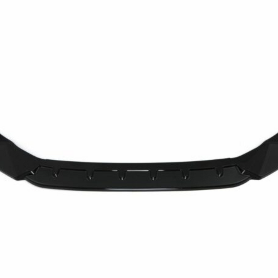 A black car front lip spoiler, featuring an angular, aerodynamic design, lies against a plain white background, emphasizing its sleek structure.