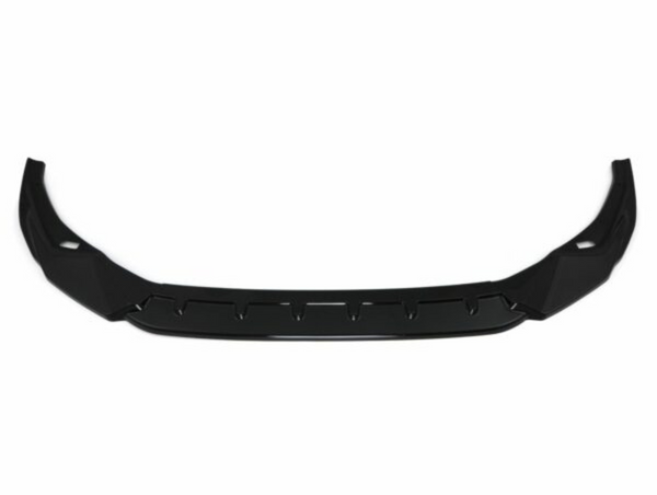 A black car front lip spoiler, featuring an angular, aerodynamic design, lies against a plain white background, emphasizing its sleek structure.