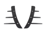 Two black carbon fiber pieces with three horizontal fins each are symmetrically aligned. They are set against a plain white background, suggesting automotive parts.