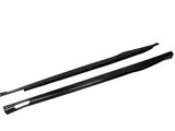 Two black carbon-fiber side skirts lie parallel, showcasing sleek design and aerodynamic shape against a plain white background.