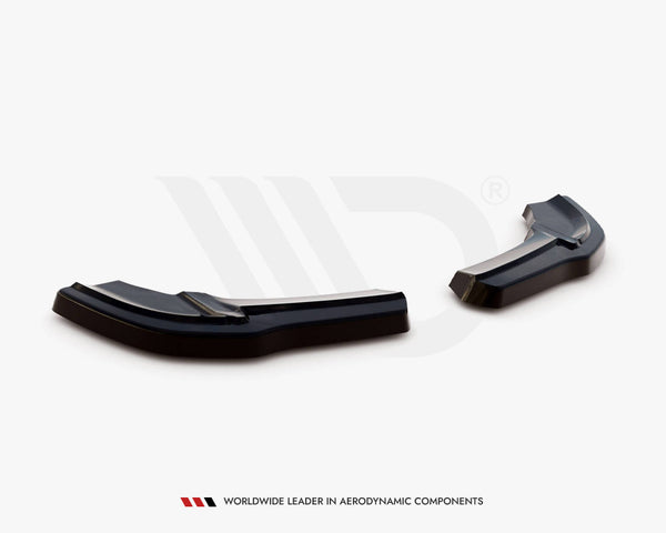 Black aerodynamic car components rest on a white surface in a studio setting. Text below reads: "WORLDWIDE LEADER IN AERODYNAMIC COMPONENTS."