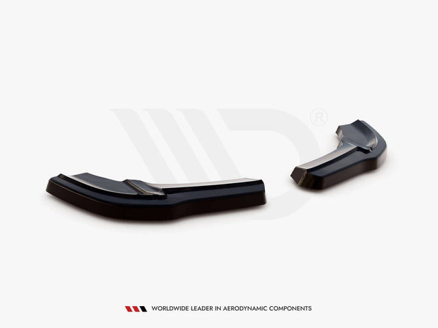 Black aerodynamic car components rest on a white surface in a studio setting. Text below reads: "WORLDWIDE LEADER IN AERODYNAMIC COMPONENTS."