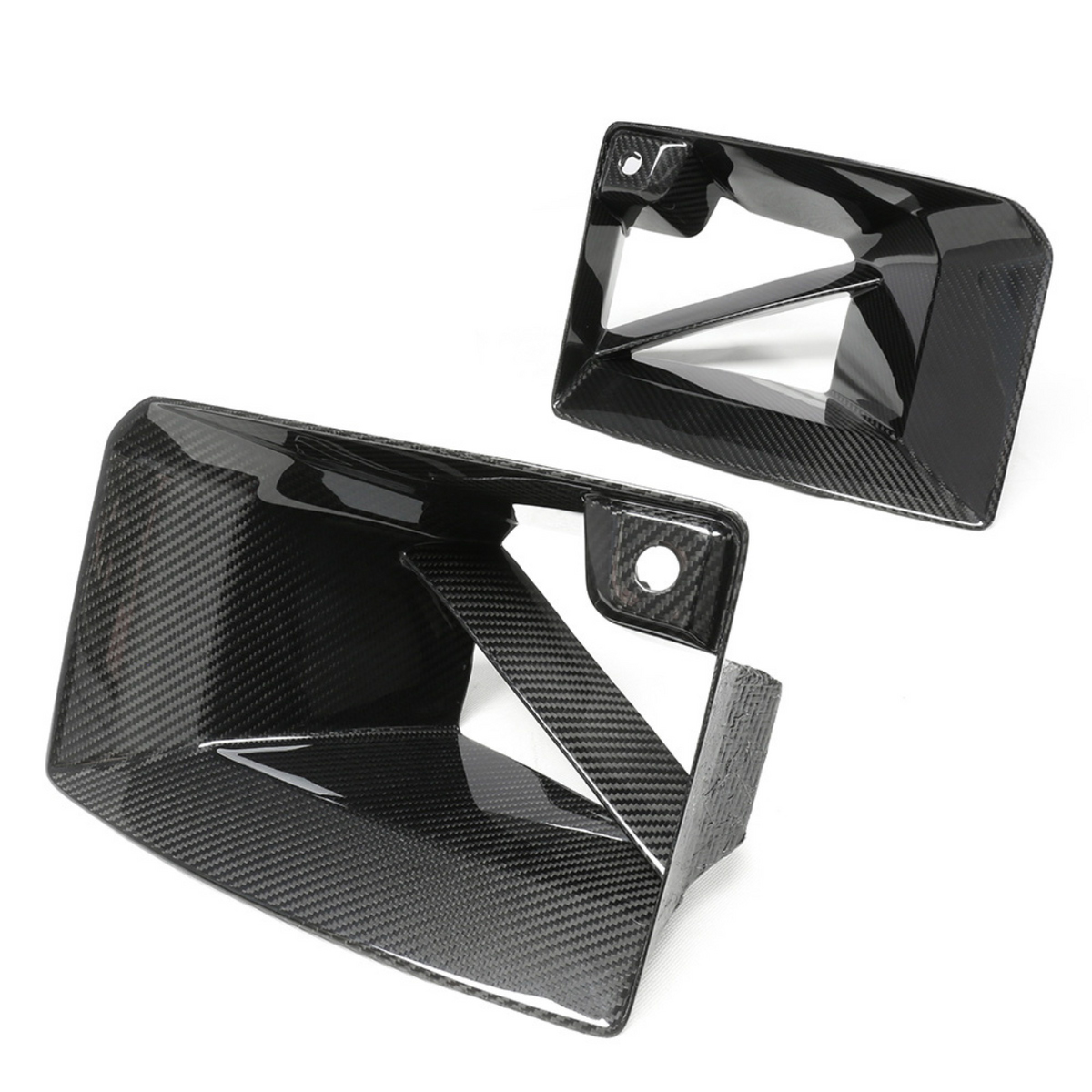 Carbon fiber air vents with a glossy finish are shown. One is angled upward and the other aligns horizontally. The white background highlights the sleek, geometric design.