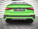 A bright green Audi RS3 is parked inside a modern garage with striped walls. The rear view highlights dual exhausts and a spoiler. The plate says 