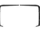 Two curved, black carbon fiber trim pieces face each other, with pointed ends curling inward, against a plain white background.