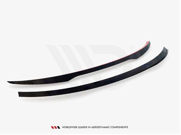 Two curved, black aerodynamic components rest on a white surface. Beneath, the text reads: "WORLDWIDE LEADER IN AERODYNAMIC COMPONENTS."