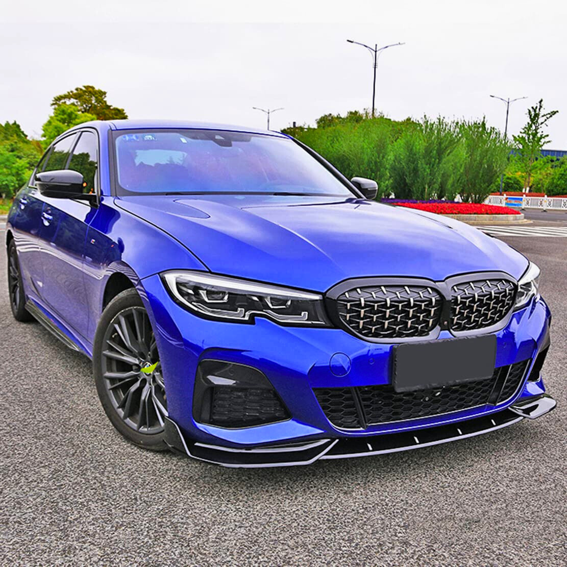 A blue car is parked on a road, featuring a sporty front grille and sleek headlights. Surrounding green trees and streetlights line the road, enhancing the urban setting.