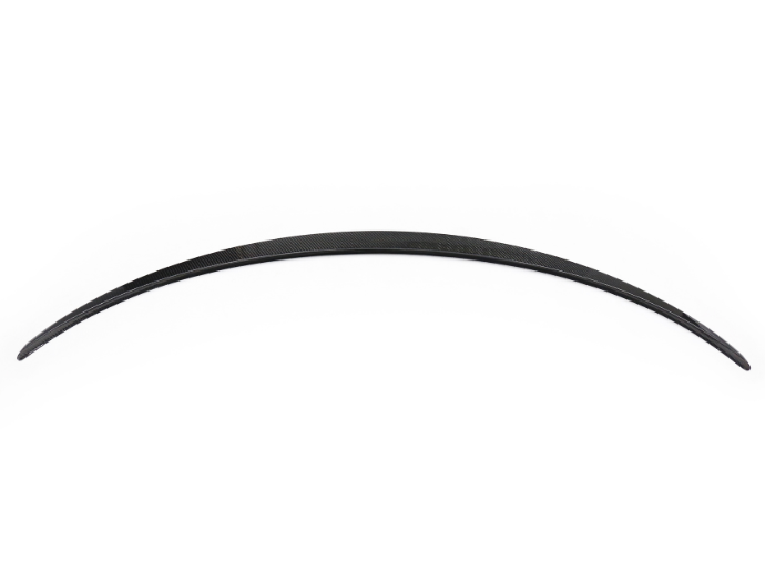A long, curved, black strip rests against a white background, displaying a sleek, aerodynamic design, potentially part of a vehicle or similar structure.