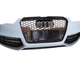 Car grille with a honeycomb pattern and four-ring emblem at the center, featuring an 