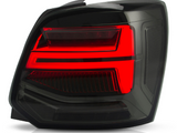 A rectangular car tail light with illuminated red sections is positioned against a white background, highlighting its sleek, modern design and layered contours.