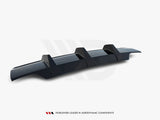 A sleek, dark-colored car rear diffuser with three vertical fins, positioned on a plain white background. Text: 
