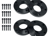 Four black circular metal spacers with holes alongside sixteen matching bolts, arranged on a plain white background, likely for automotive wheel fitting or adjustment.