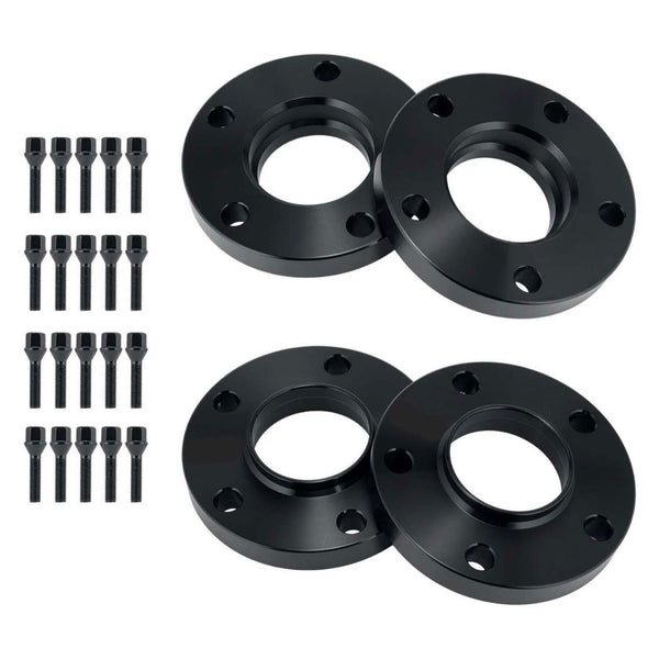 Four black circular metal spacers with holes alongside sixteen matching bolts, arranged on a plain white background, likely for automotive wheel fitting or adjustment.