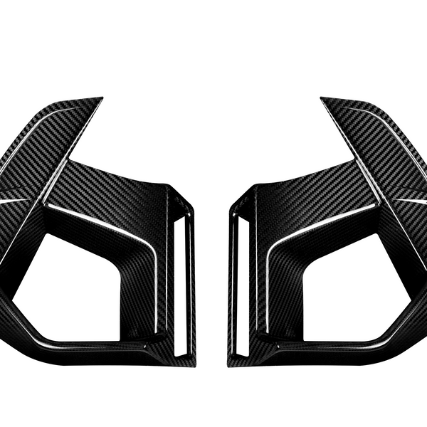 Two angular carbon fiber car parts face each other, featuring sleek lines and sharp edges, set against a plain white background.